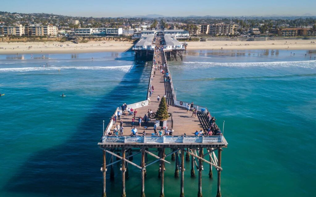 San Diego Beach in Winter Visitors enjoying a sunny San Diego beach and pier during winter