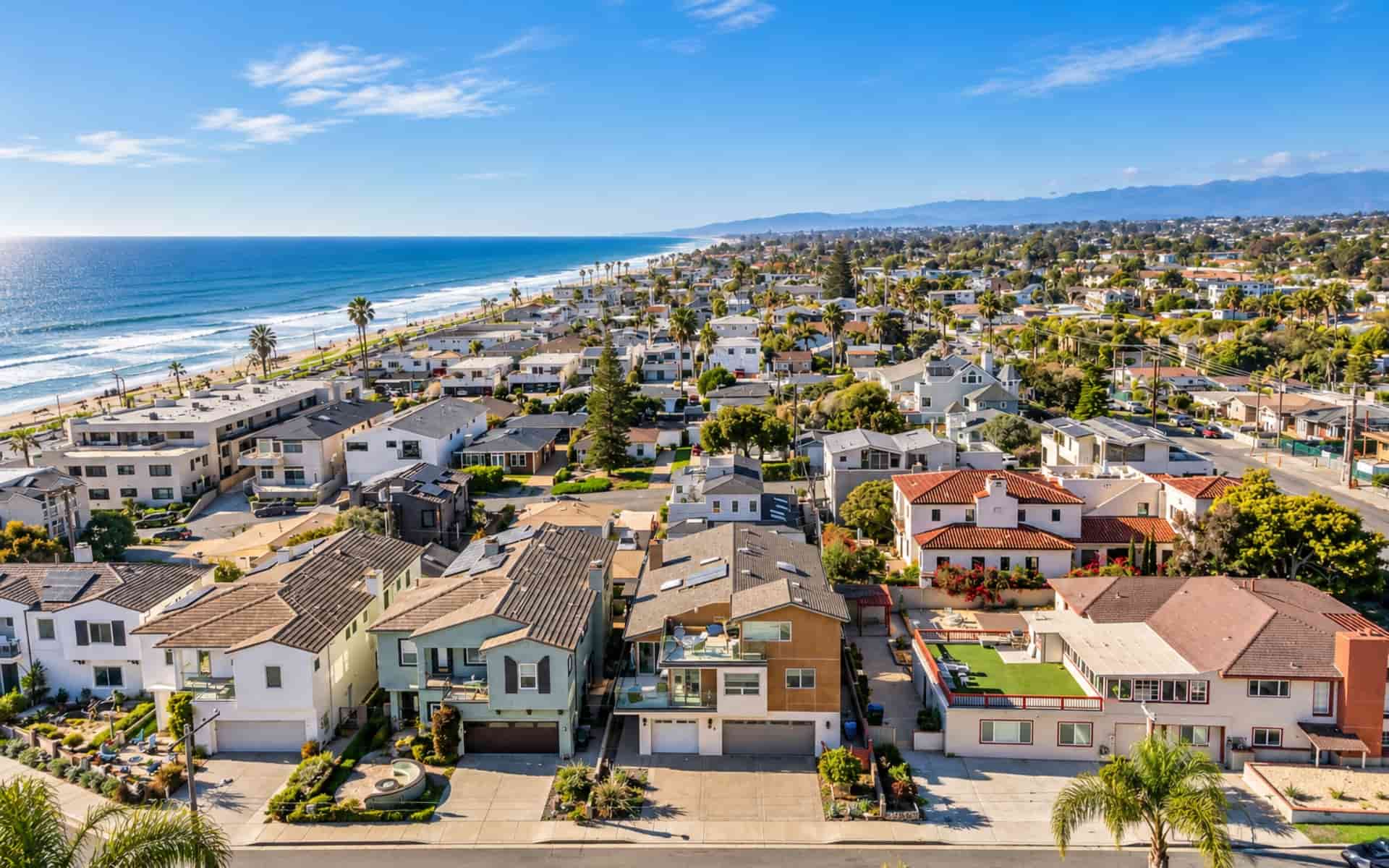 Aerial view of a Southern California coastal neighborhood near the beach, showing the type of location that can appeal to vacation rental guests.