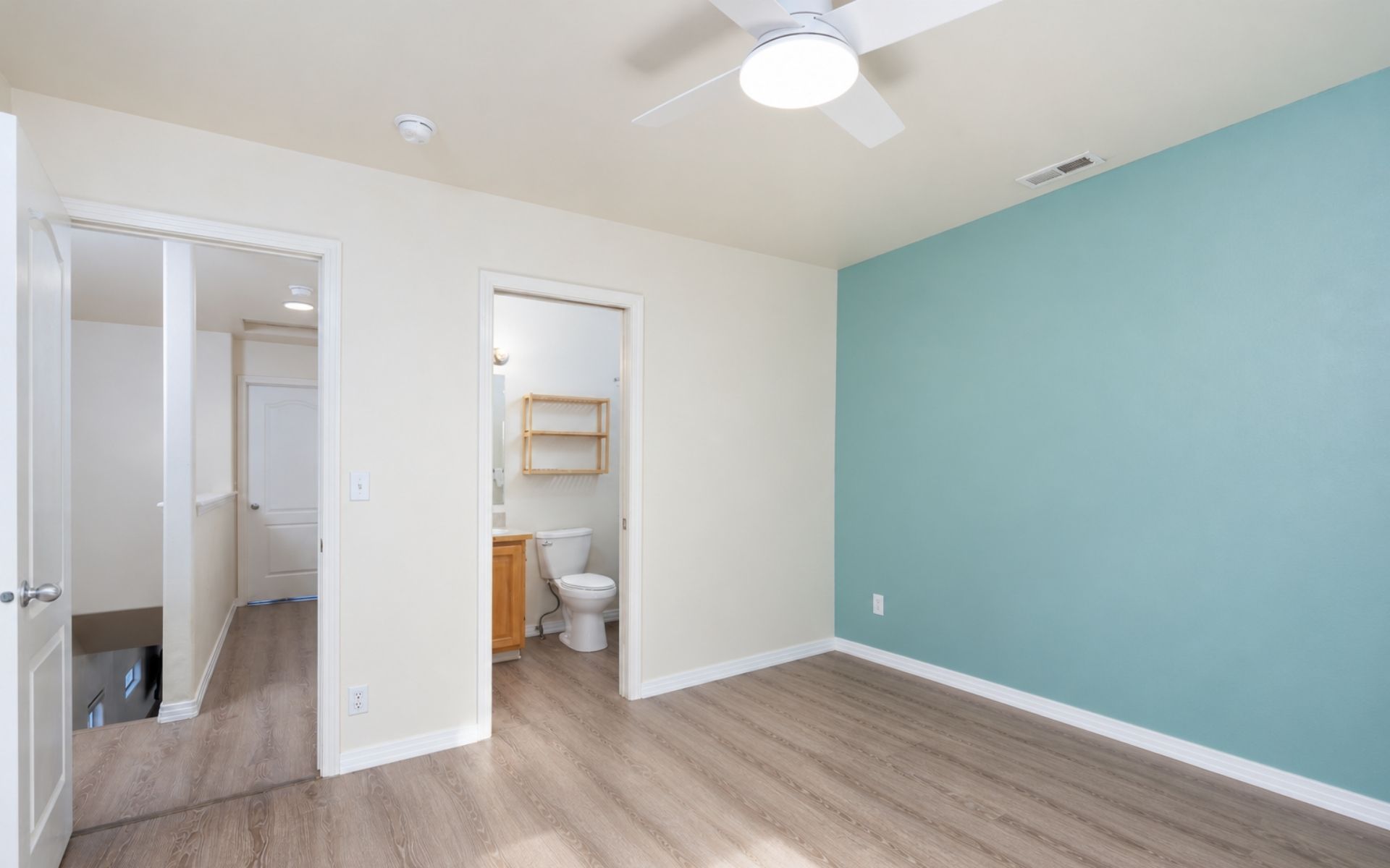 Clean, unfurnished bedroom with neutral walls, tiled flooring, double windows, and a ceiling fan in a Boise rental home.